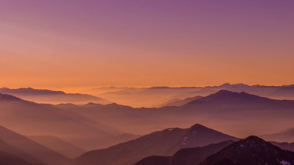Breathtaking view of mountain ranges with a vibrant sunset sky in India.